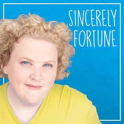 Fortune Feimster smiling beside the works 'Sincerely Fortune.'